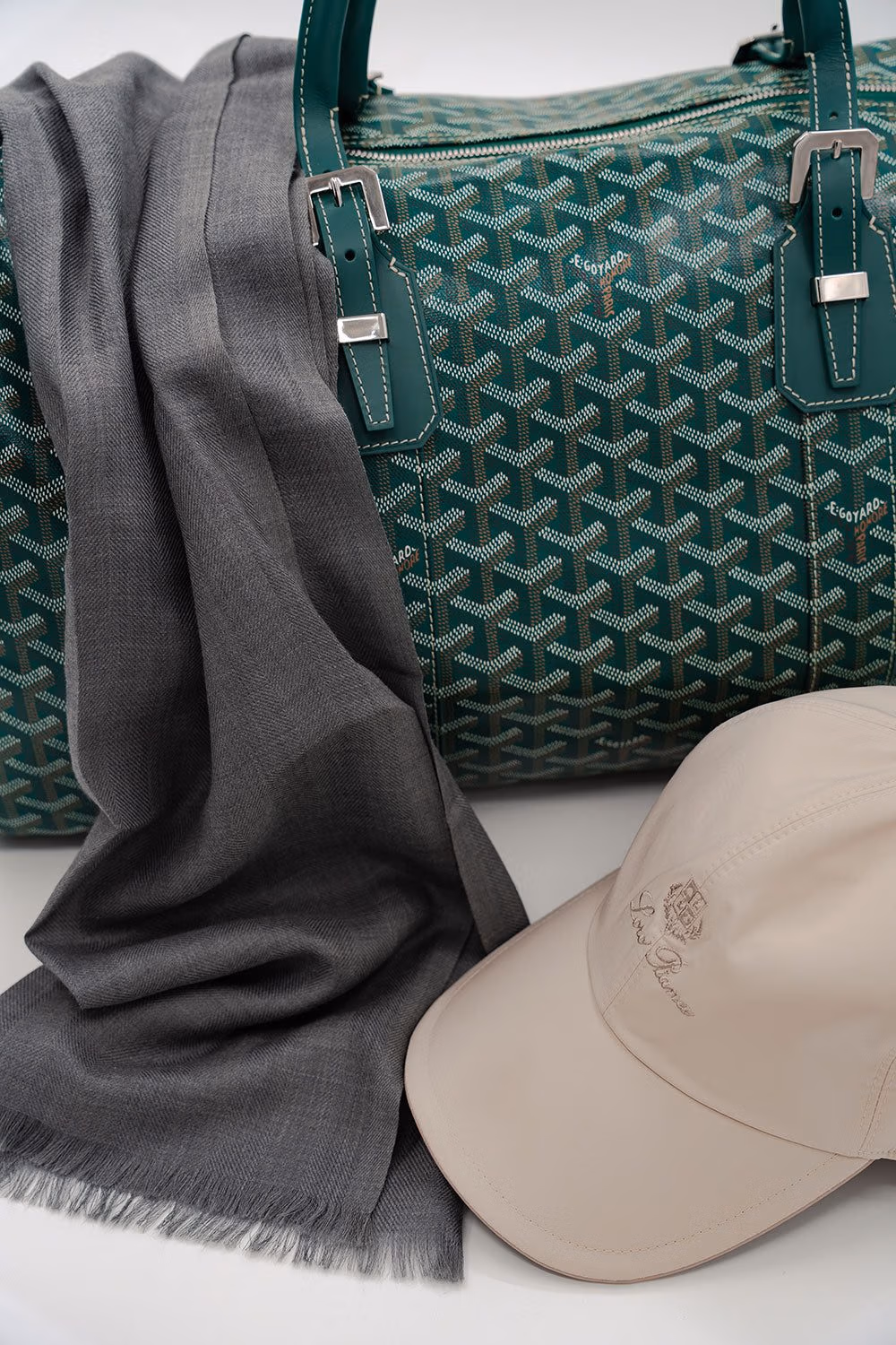 Grey scarf, green monogram tote bag and beige cap