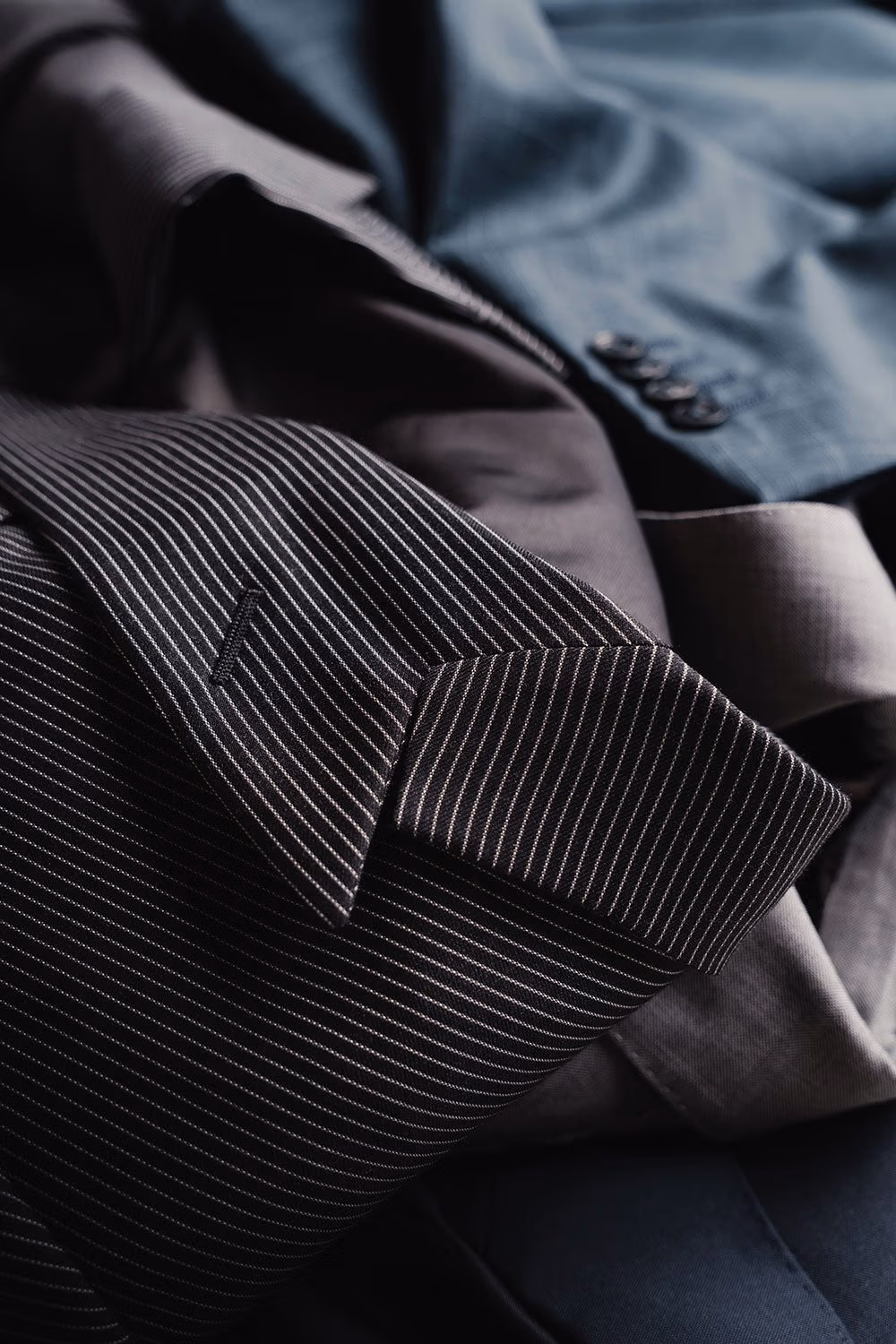 Close-up of pinstripe and grey suit jackets